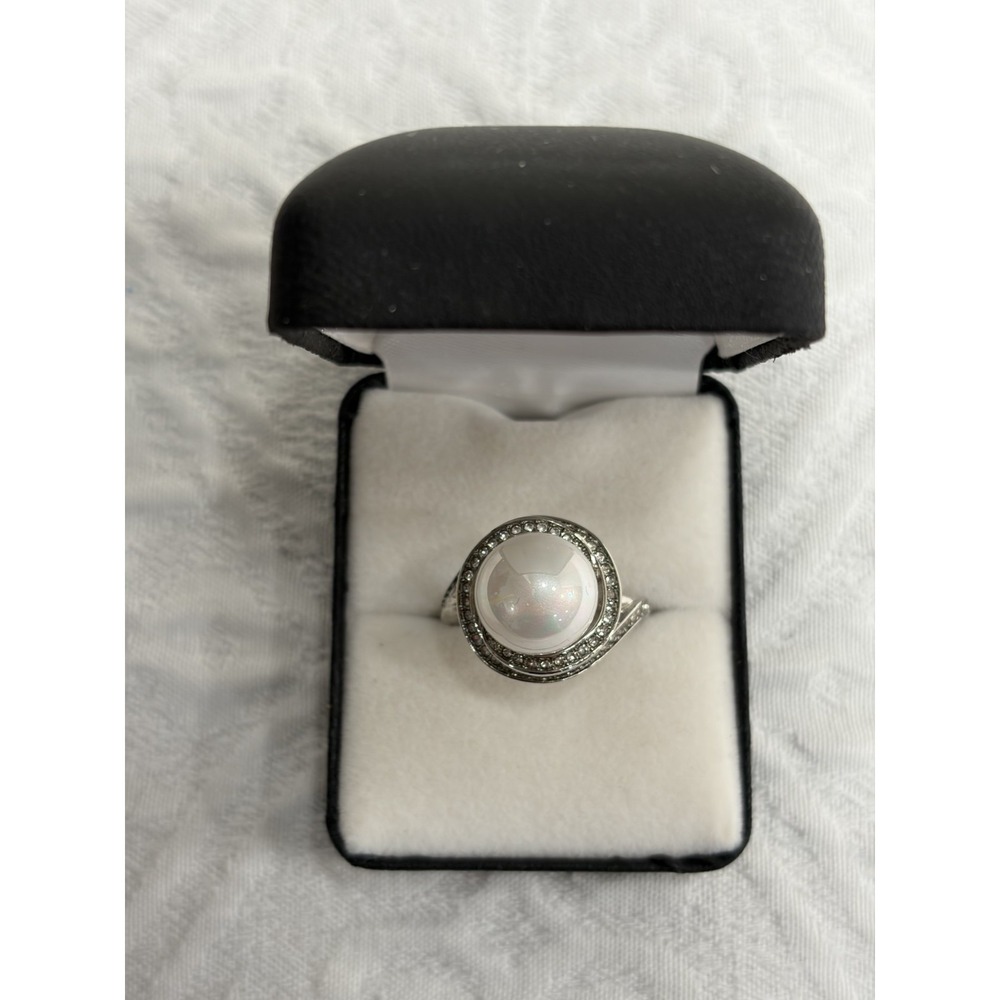 White faux pearl centered in a swirling pave set CZ bypass band size 9.5